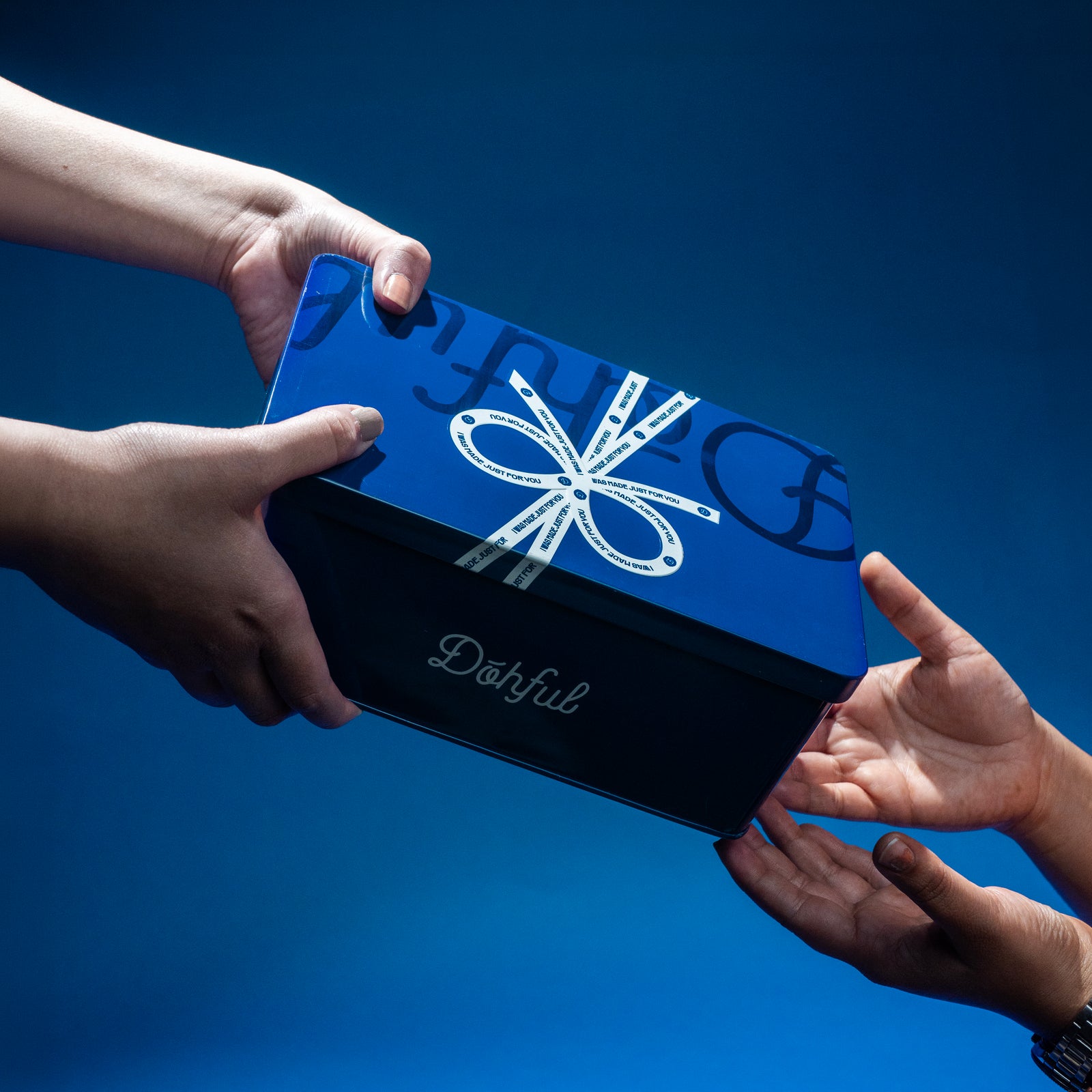 A Dohful gift box being handed over